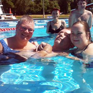 color photo of 5 people in a swimming pool