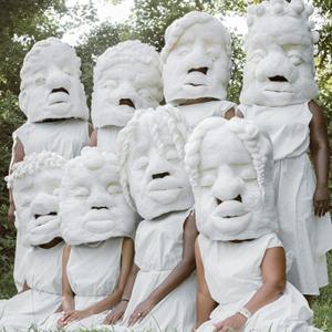 photo of 8 women wearing large wool masks