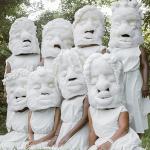 photo of 8 women wearing large wool masks